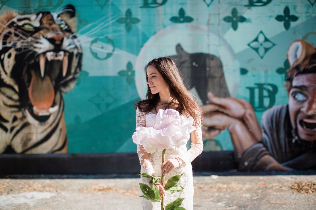 Olivia poses against cobblestone streets for her Charleston bridal portraits.
