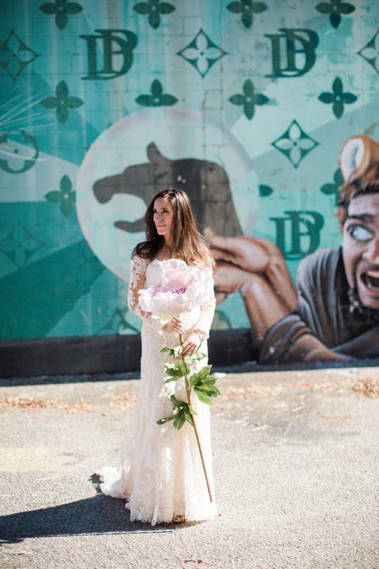 Olivia stands in front of a wrought iron gate for her bridal portrait session.