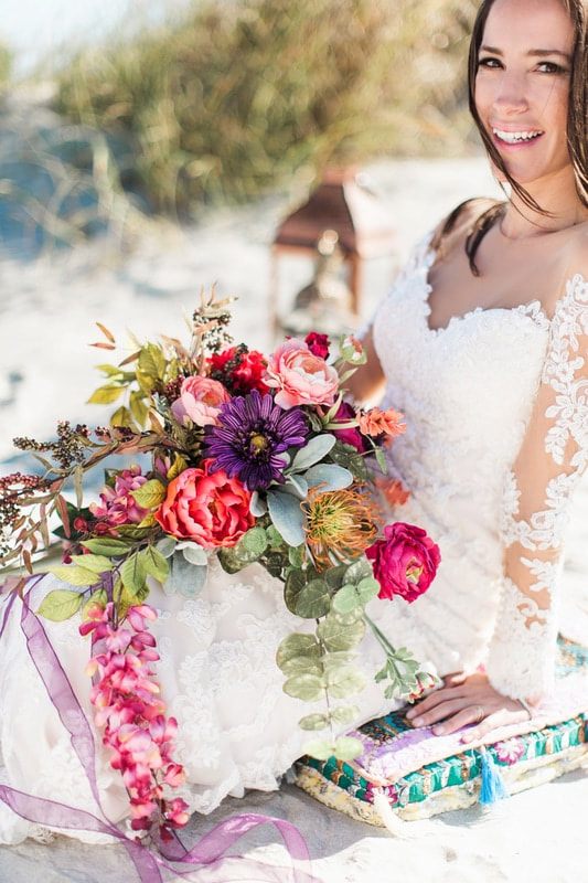 Olivia poses near greenery for a soft, romantic Charleston bridal photo.