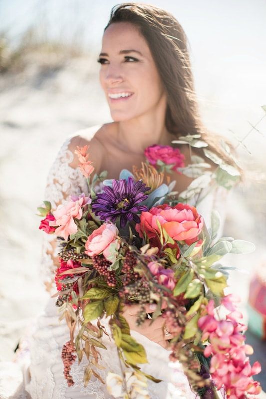 A close-up of Olivia's bridal jewelry and hair detail in Charleston.