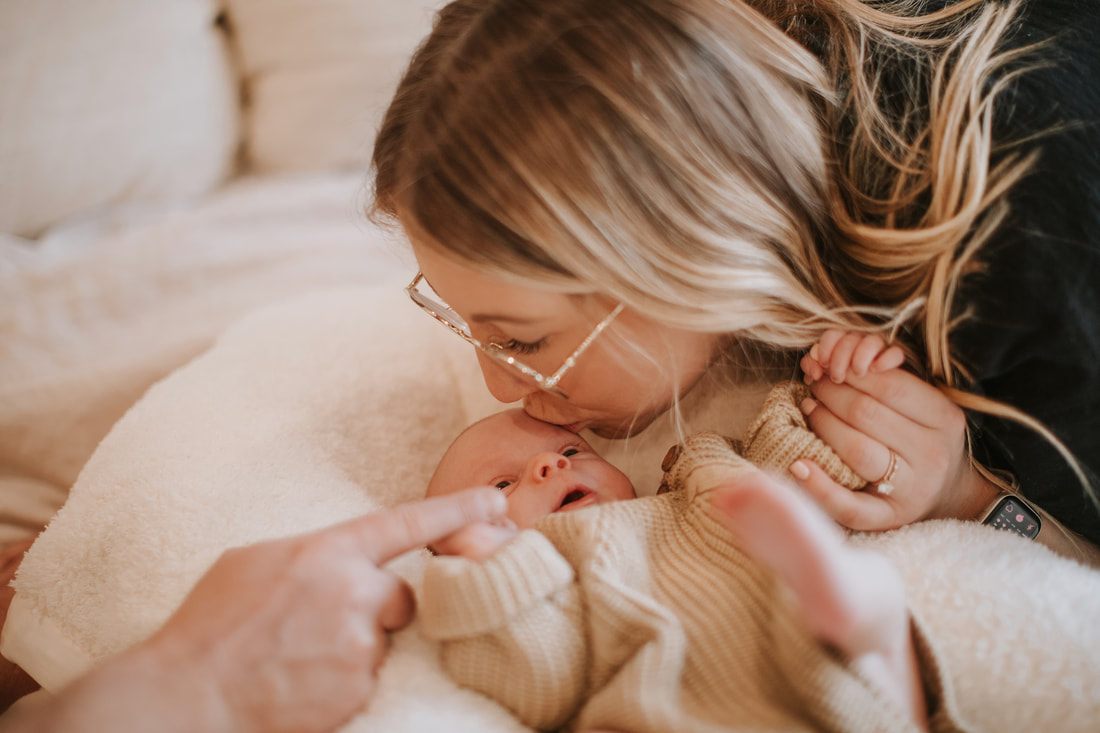 Newborn baby sleeping in a woven basket during a home session