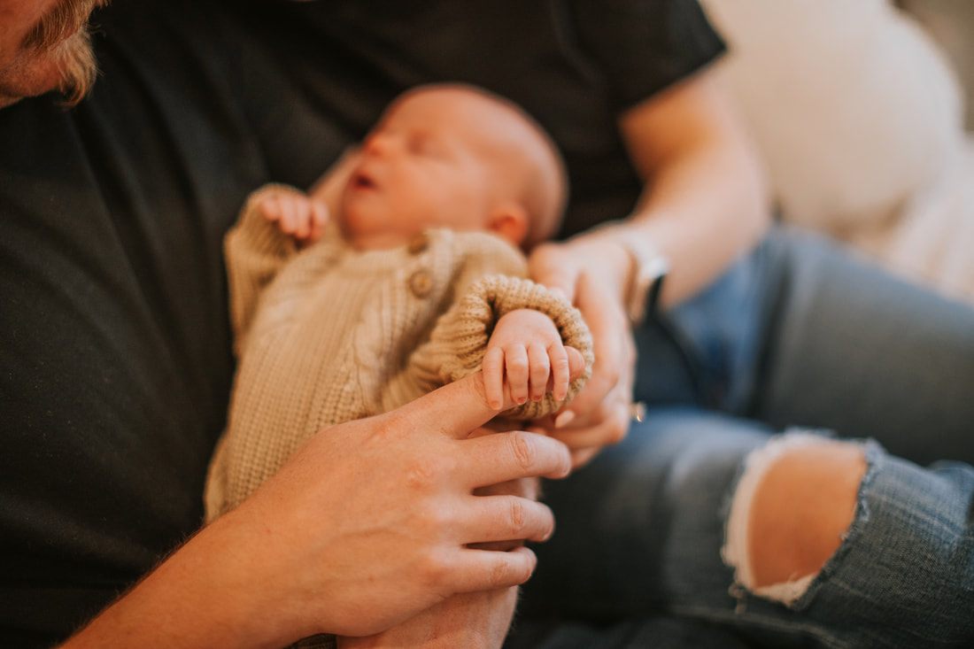Mother gently cradling her newborn daughter during a quiet moment