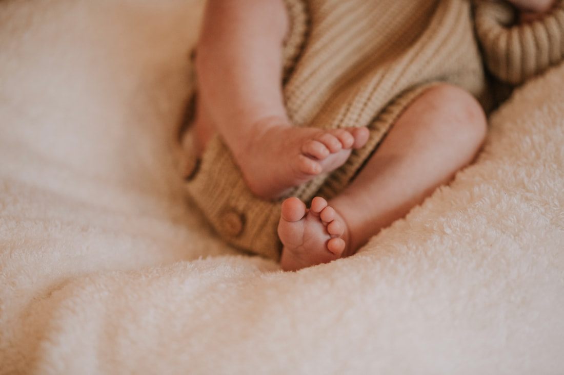 Father holding his newborn daughter in a quiet nursery moment