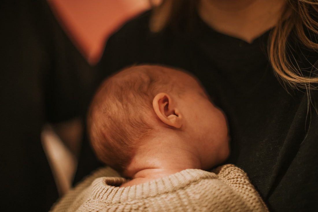 Newborn baby swaddled and resting in the nursery