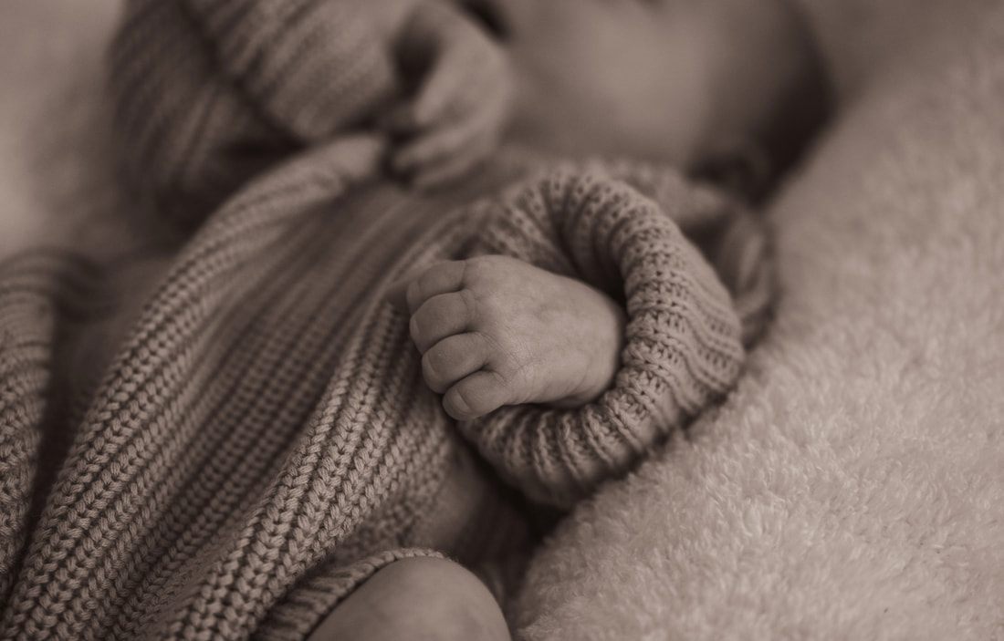 Newborn baby's feet and toes in soft natural light