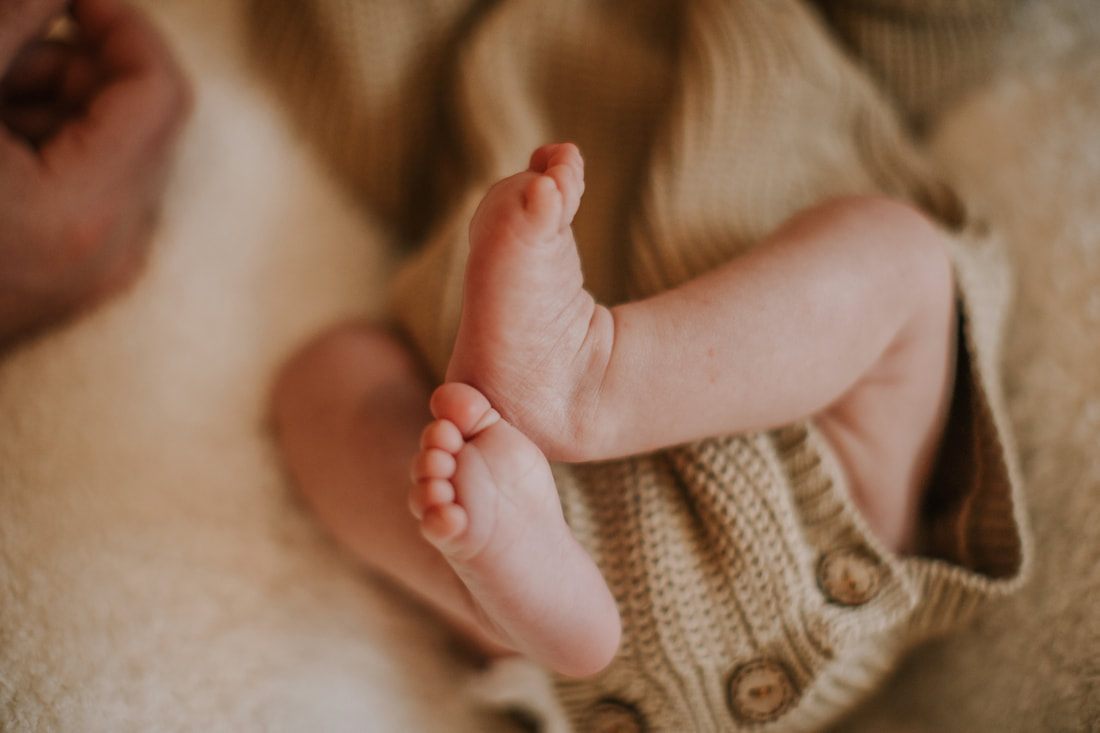 Newborn baby swaddled and resting in a cozy nursery corner