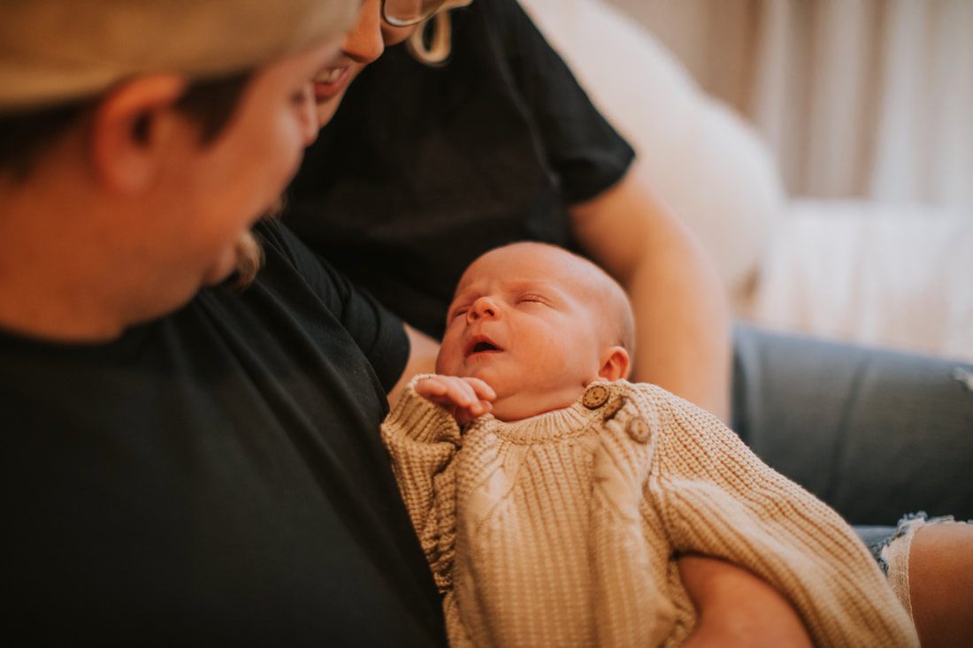 Family portrait of the Pittis family with their newborn