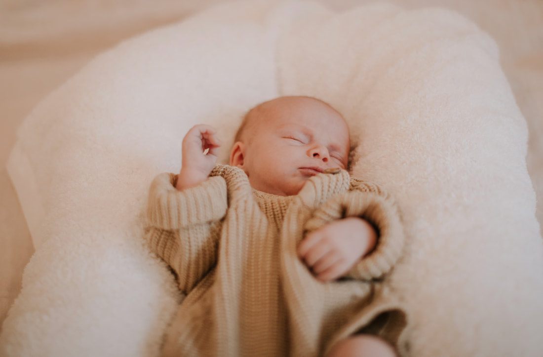 Family portrait of new parents with their newborn daughter at home