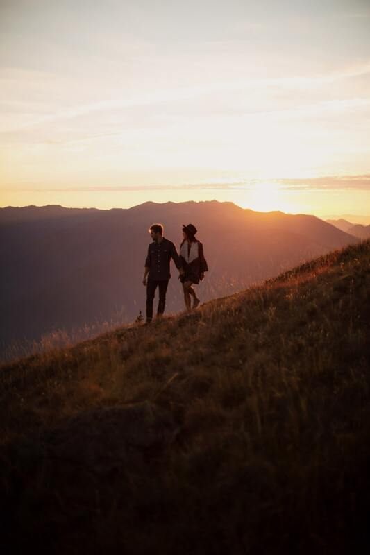 Couple silhouetted against a golden Hurricane Ridge sunset