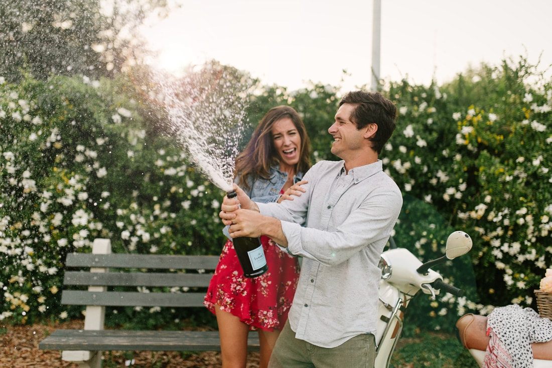 Couple riding a vespa together during their Charleston anniversary session