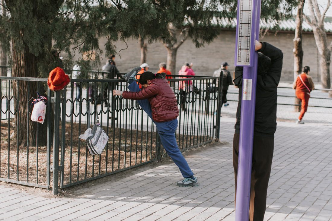 Elderly locals gathered in a park near the Temple of Heaven, Beijing