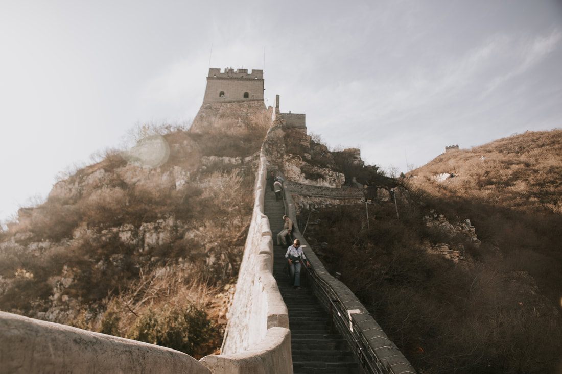Climbing a steep, uneven section of the Great Wall of China