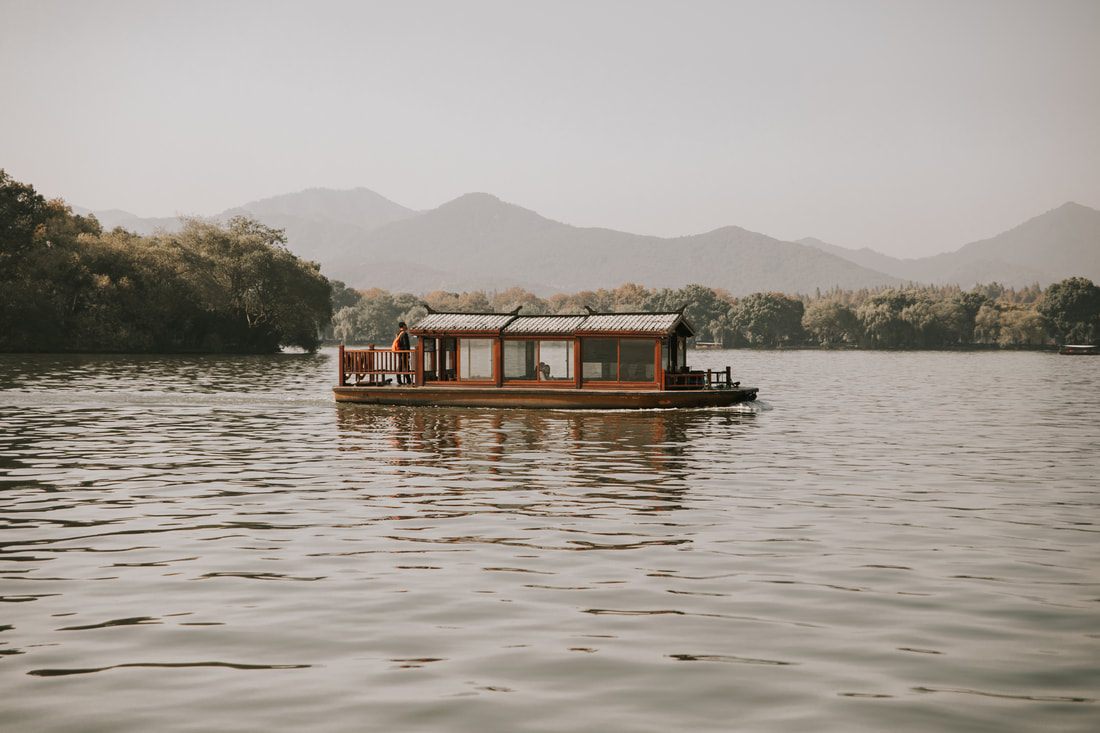 Scenic stone pathway along the West Lake shoreline in Hangzhou