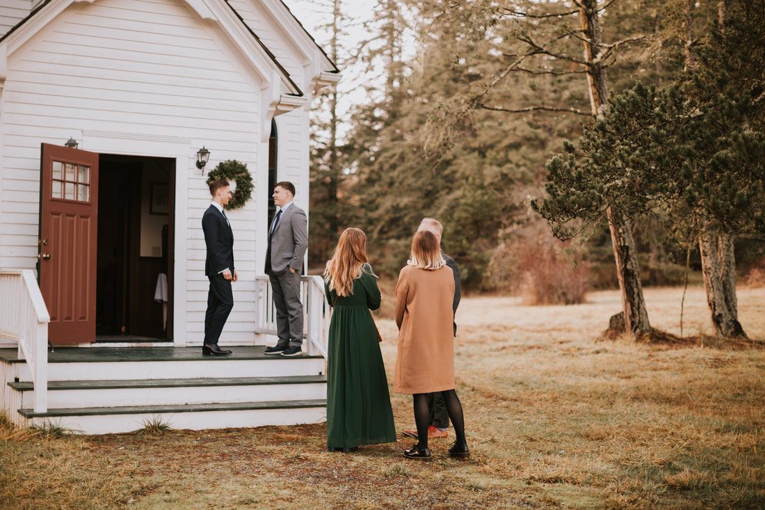 Bridesmaids helping the bride into her gown