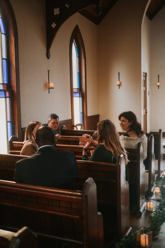 Bridesmaids helping the bride into her gown