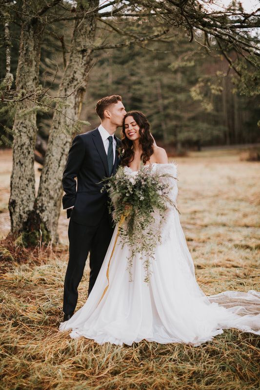 Newlyweds walking hand in hand through the woods