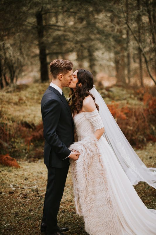Bride twirling her gown for portraits in the forest