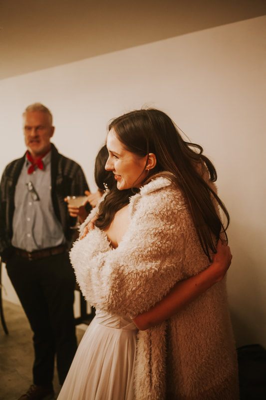 Guests laughing together during dinner at the reception