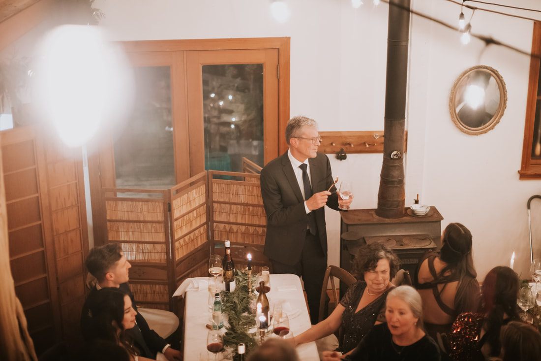 Guests laughing together during dinner at the reception