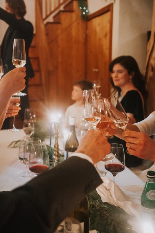 Candid moment of guests celebrating around the reception table
