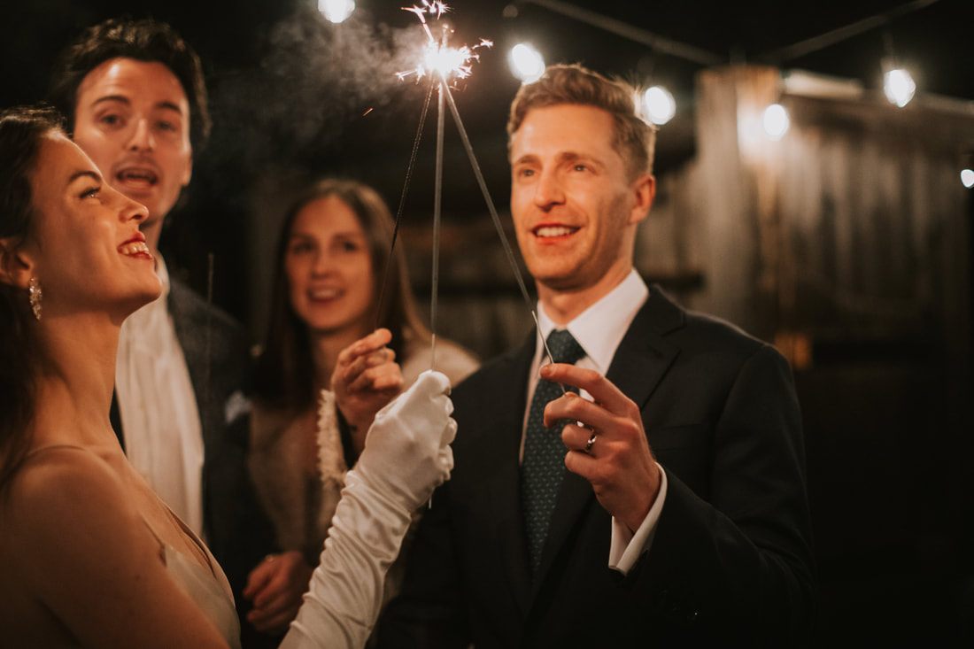 Guests laughing together during dinner at the reception