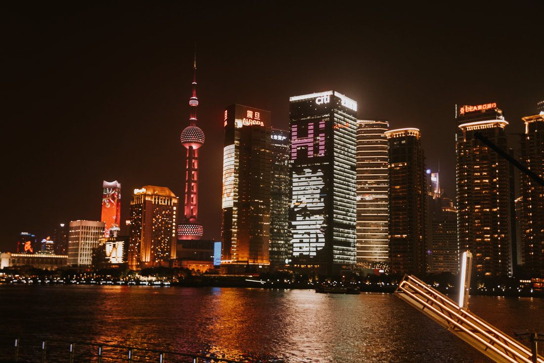 Shanghai skyline of modern skyscrapers viewed from a river cruise.