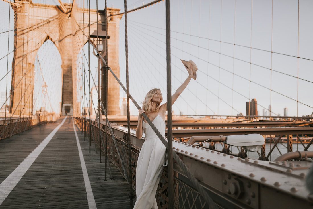 Valentina posing in a bridal romper from Schone Bride on a Brooklyn street