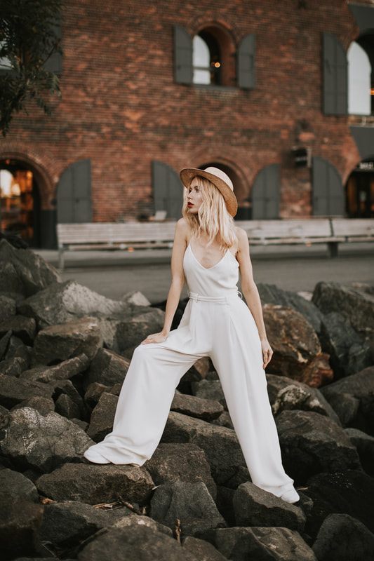 Valentina posing in a bridal romper from Schone Bride on a Brooklyn street