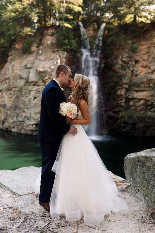 Close-up bridal portrait among green foliage at the waterfall wedding site