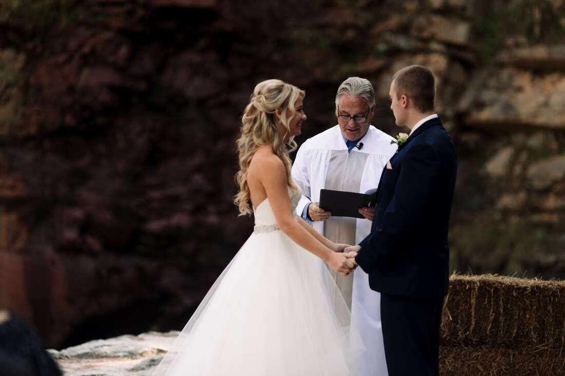 Bride walking through the forest toward the ceremony site