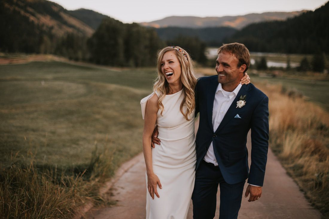 Groom helping the bride navigate the windy valley terrain