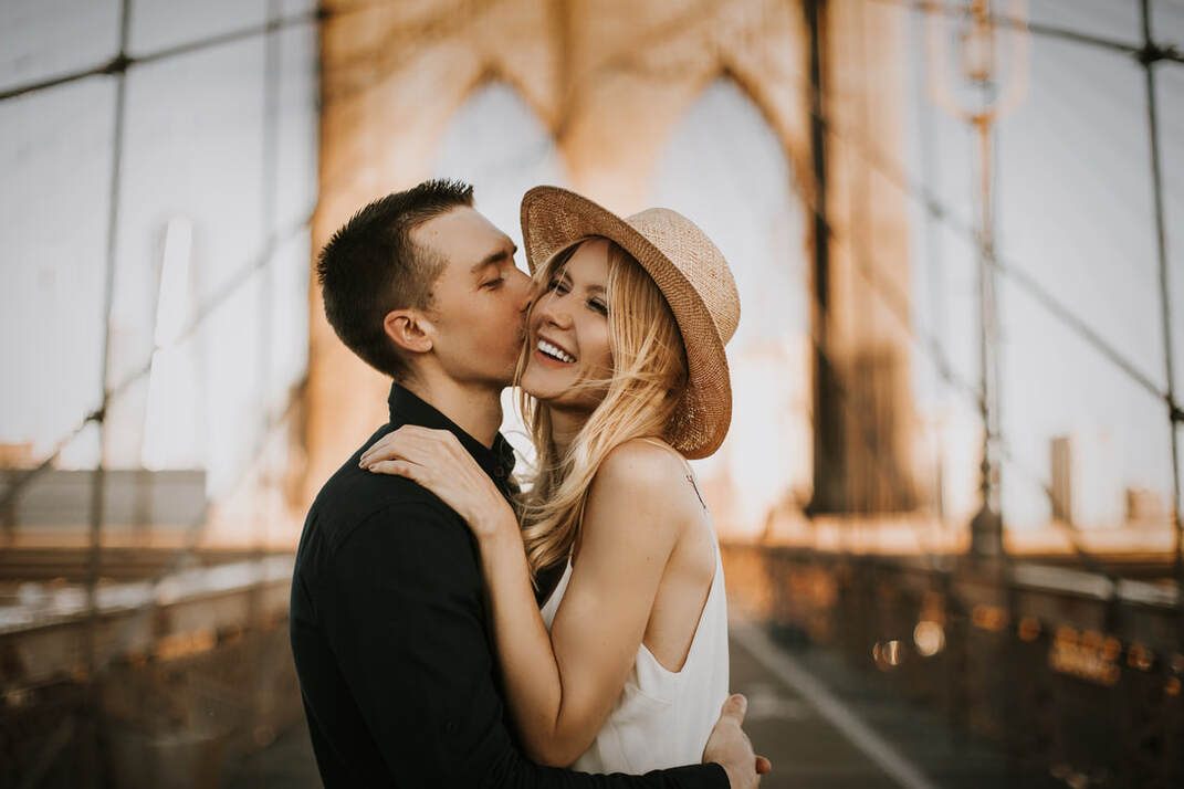 Engaged couple walking hand in hand through New York City for their engagement photos
