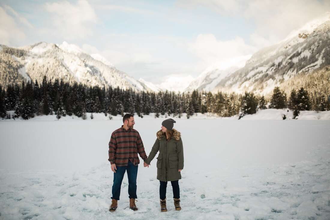 Couple in snowshoes pausing on the trail above Snoqualmie, Washington