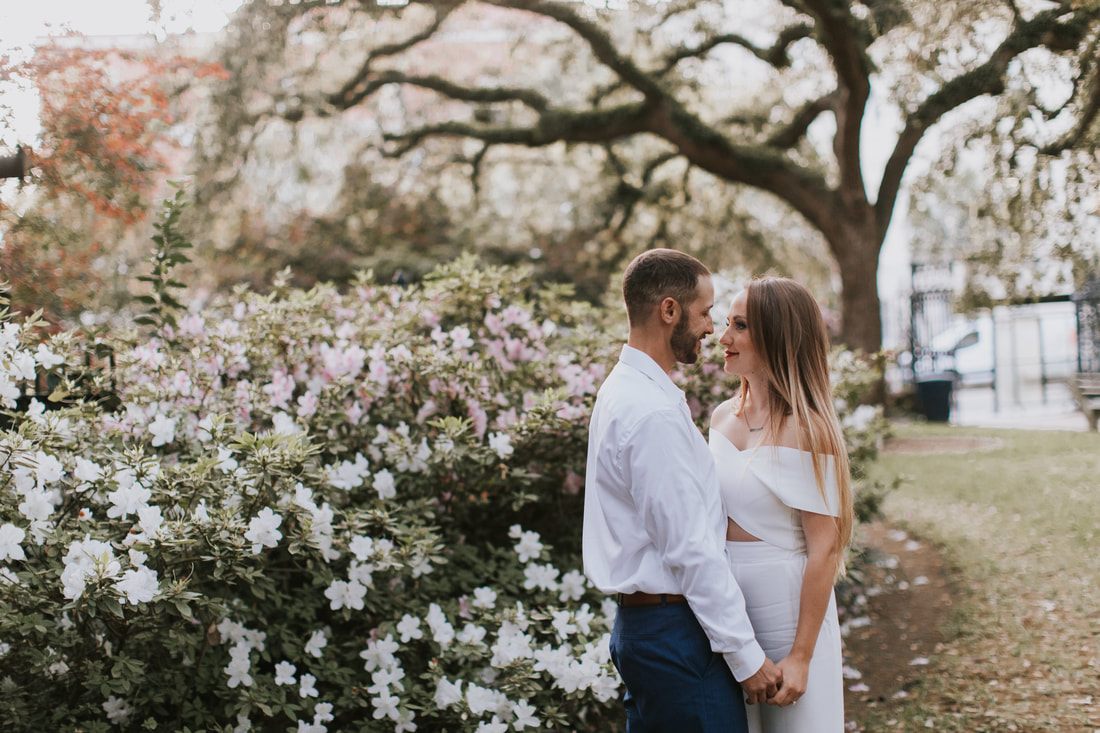 Couple walking away together down a tree-lined Charleston side street