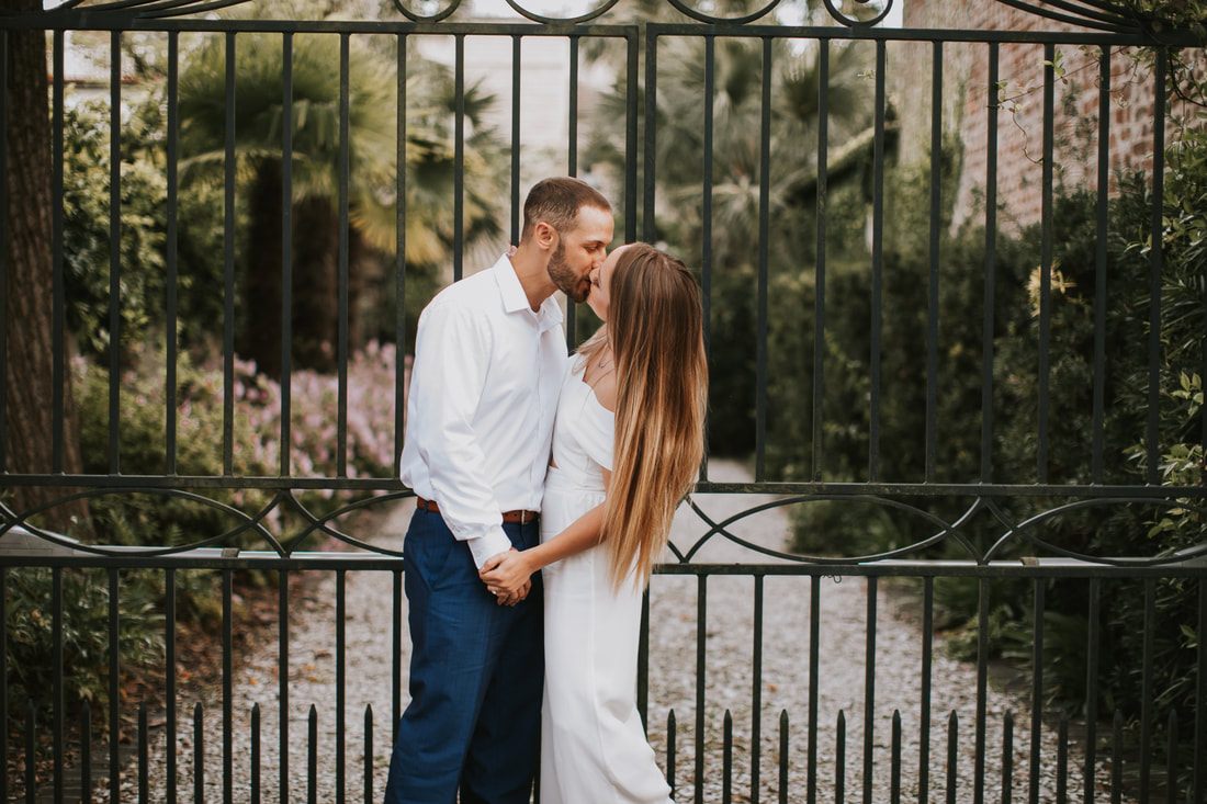Engaged couple portrait with historic Charleston architecture in the background