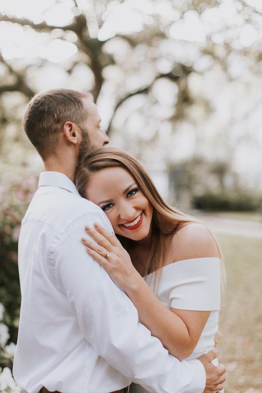 Couple sharing a laugh while walking through downtown Charleston