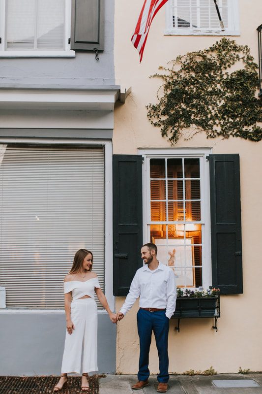 Engagement portrait under greenery on a Charleston cobblestone street