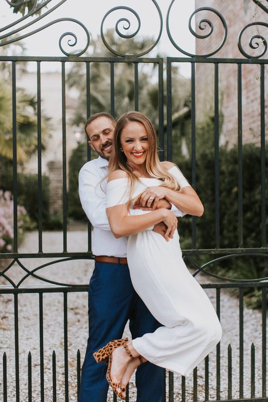 Engaged couple walking toward the camera on cobblestone Chalmers Street