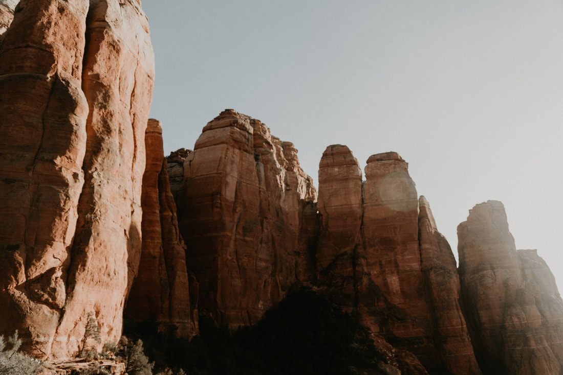 Golden hour light over Sedona's rust-colored rock formations.