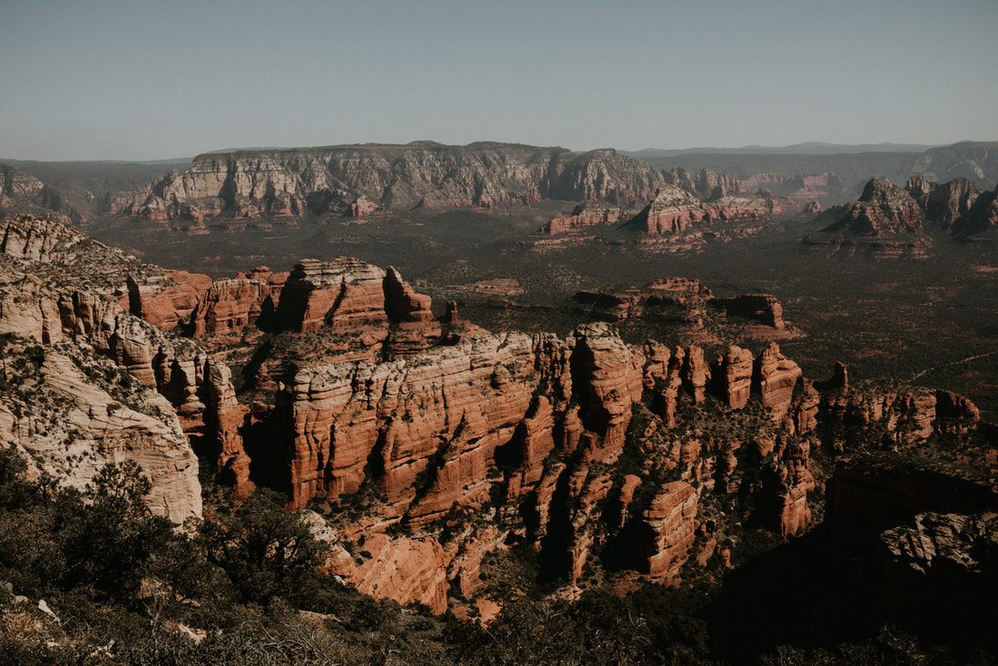 Wide desert view of Sedona's red rock canyons and buttes.