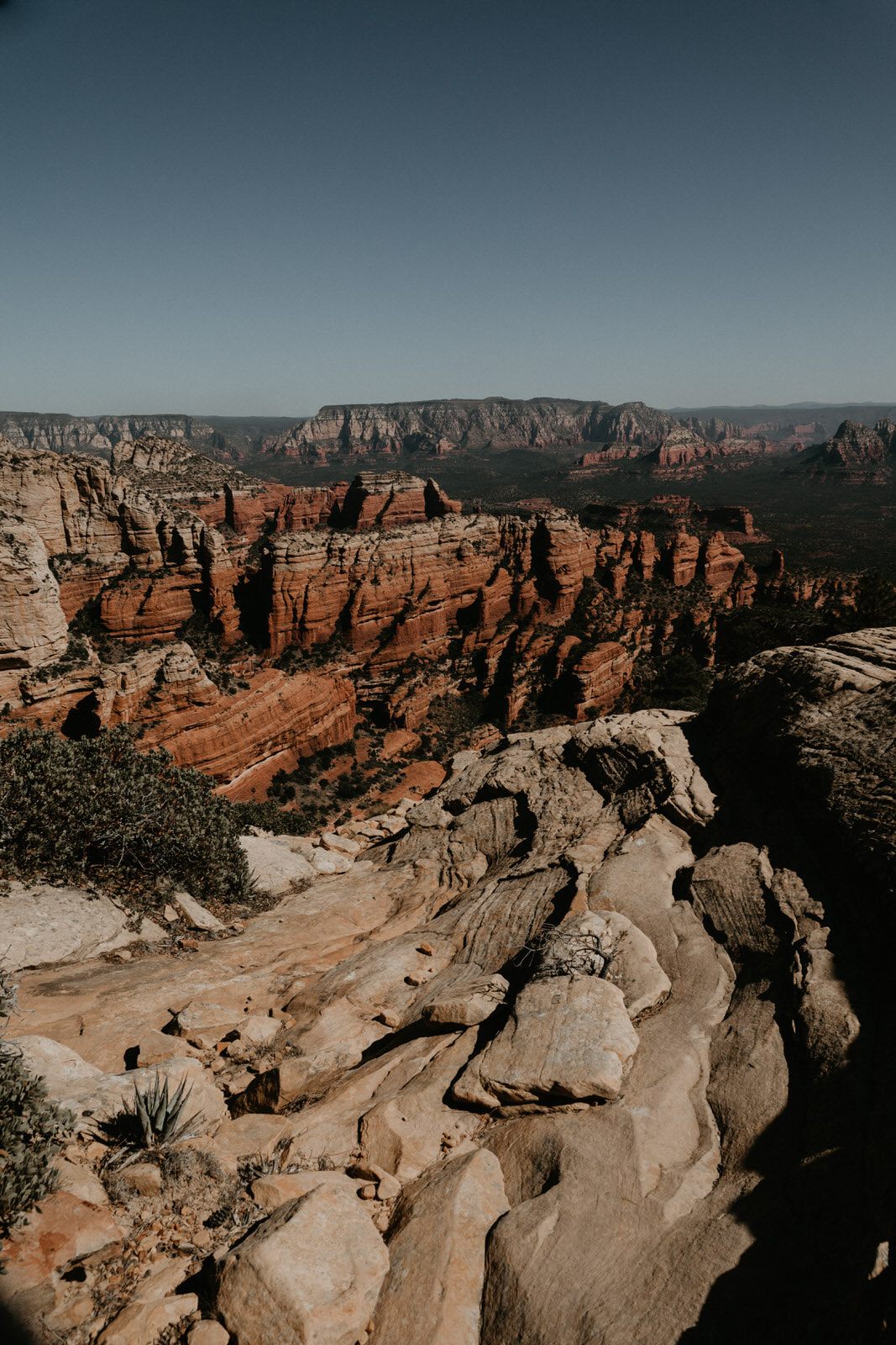 Close-up travel photo of Sedona's layered red rock cliffs.