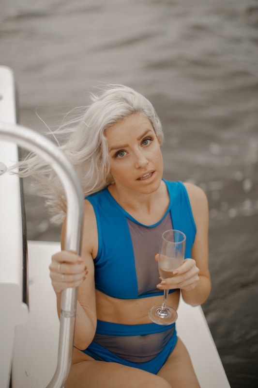 A model posing near the waters edge with a breezy, summery look