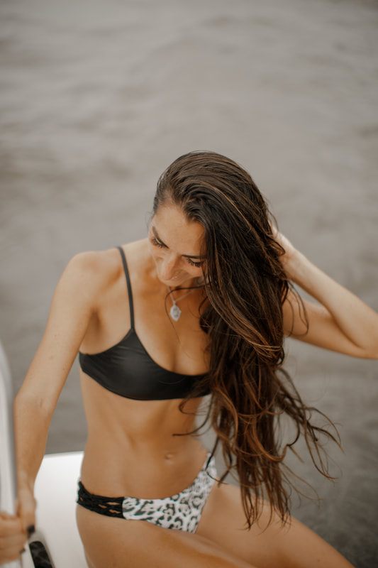 One of the Bikini Beach Australia models styled for a beach lifestyle shot in soft golden-hour light