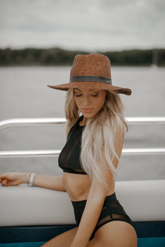 A campaign model posing in a swimsuit styled for the brands online catalog