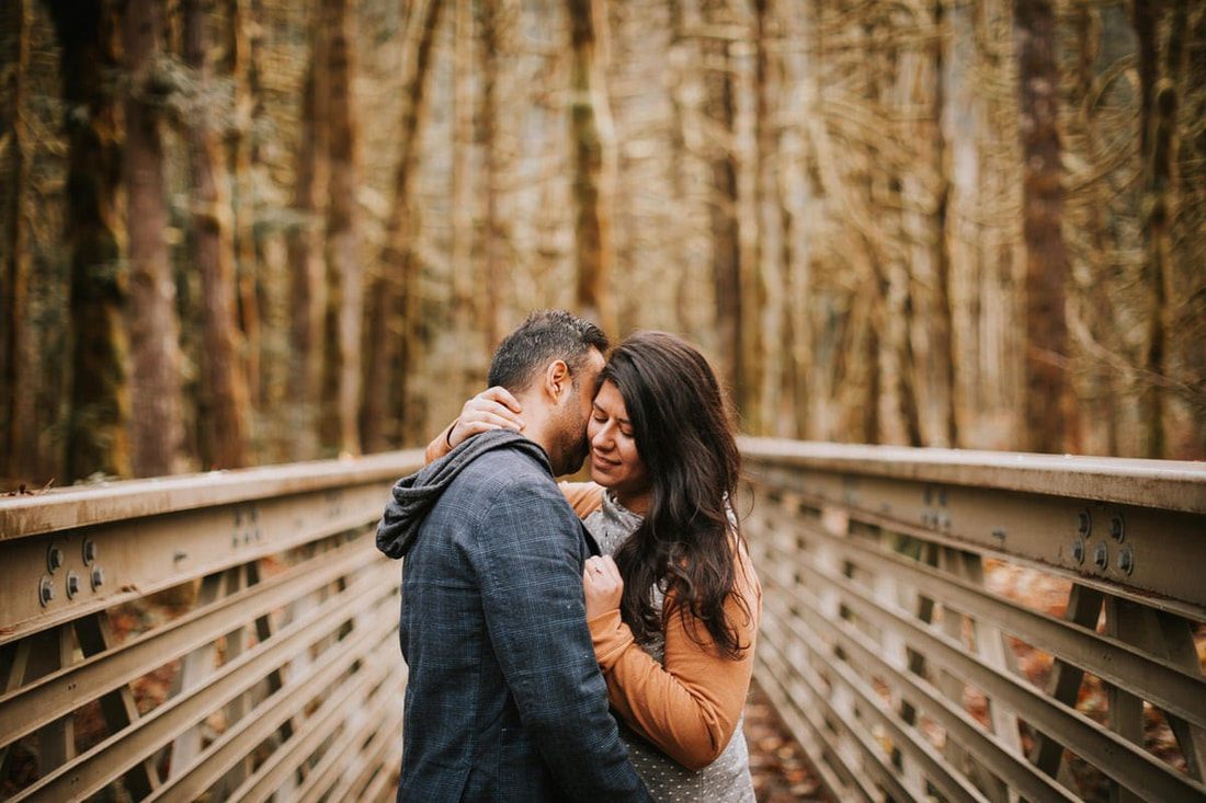 Newly engaged couple relaxing on the porch at That PNW Cabin in Washington