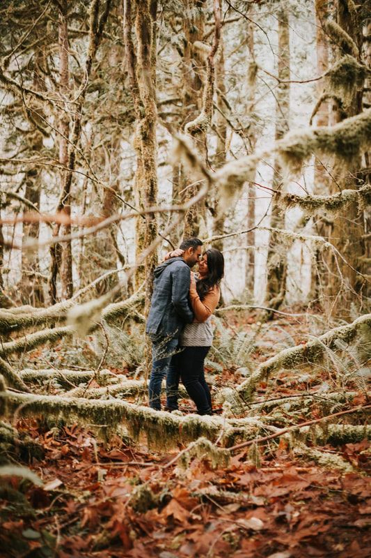 Close-up engagement portrait in front of the cabin's vintage trailer