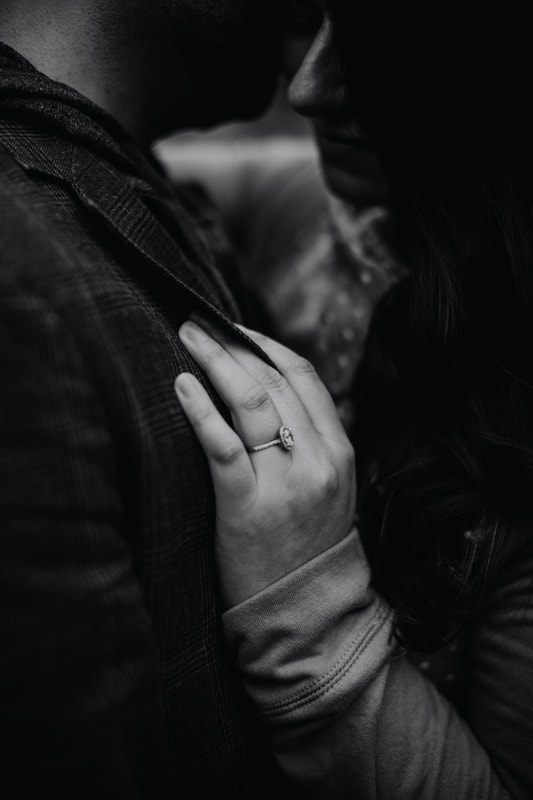 Close-up of the couple's hands during their cabin engagement session