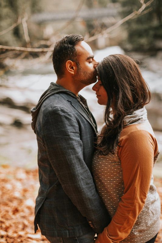 Candid portrait of the couple laughing together outdoors