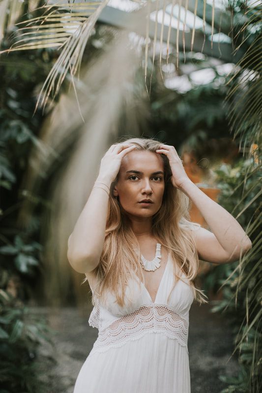 Natural light portrait session inside a Charleston greenhouse