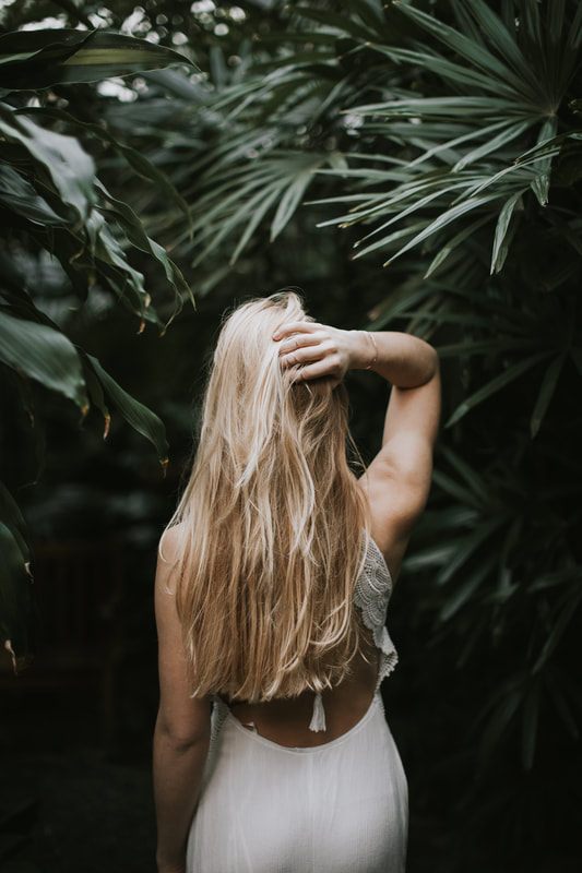 Natural light portrait session inside a Charleston greenhouse